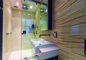 a bathroom with a sink and a shower at Pearls of Umhlanga Multi-Story Penthouse in Durban