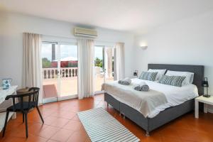 ein Schlafzimmer mit einem großen Bett und einem Balkon in der Unterkunft Villa Atlantico in Poço Partido + 53 Fotos