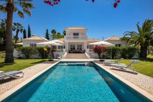 eine Villa mit einem Swimmingpool vor einem Haus in der Unterkunft Villa Atlantico in Poço Partido