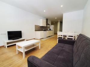 a living room with a couch and a table at BAHíA APARTAMENTOS TURÍSTICOS in Foz