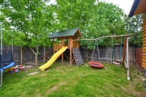 a playground with a slide and a swing at Noclegi u Kanara in Lutowiska