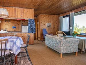 a kitchen and living room with a table and chairs at Holiday home Augustenborg VI in Augustenborg