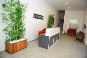 a waiting room with plants and a sign on the wall at Lofts Alanya Lina in Okurcalar