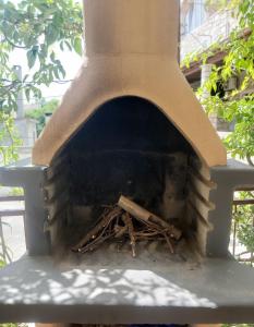a brick oven with a pile of wood in it at Apartment Nela in Brna