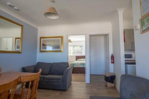 a living room with a couch and a table at Kipling Villa With Sea Views in Bideford