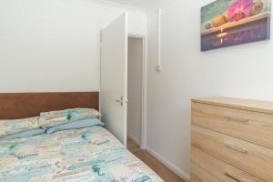 1 dormitorio con cama y tocador de madera en Kipling Villa With Sea Views, en Bideford