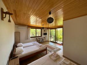 a bedroom with two beds and a wooden ceiling at Incekum Pansiyon in Bodrum City