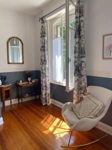 a living room with a chair and a window at La Maison du Markstein in Linthal