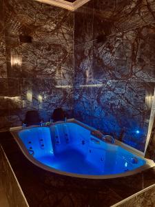a blue tub in a room with a stone wall at Aysultan Stone House in Uchisar +53 photos
