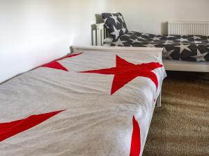 a bedroom with a bed with a red star on it at Flint House in Sheringham
