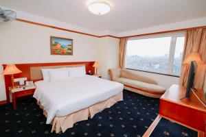 um quarto de hotel com uma cama e uma grande janela em A25 Luxury Hotel em Hanói