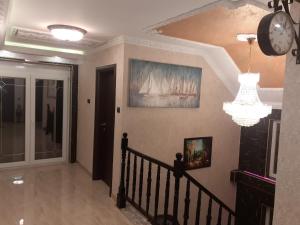 a hallway with a clock and a chandelier at Hacijenda Vidikovac in Šabac