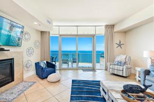 a living room with a fireplace and a view of the ocean at Turquoise 1908 C Turquoise Place in Orange Beach