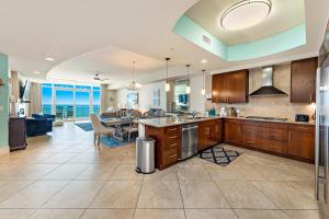 a large kitchen with a table and a dining room at Turquoise 1908 C Turquoise Place in Orange Beach