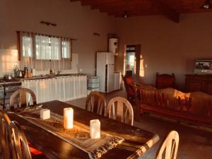 a kitchen with a wooden table with candles on it at Don Segundo in Lobos