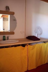 a bathroom with a sink and a mirror at Nestudio : studio pour 2 / 3 personnes in Saint-Laurent-de-Neste