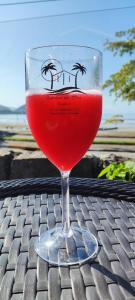 ein Glas rotes Getränk auf einem Tisch in der Unterkunft Pousada Quintal do Mar in Ubatuba