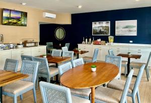 a dining room with wooden tables and chairs at Beach View Hotel in Rehoboth Beach