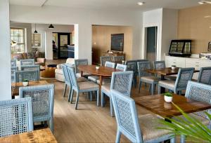 a dining room with wooden tables and chairs at Beach View Hotel in Rehoboth Beach