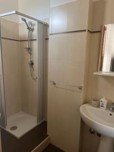 a bathroom with a shower and a sink at Leone di Nemea - Νεμέος λέων in Reggio Calabria