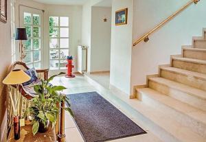 a living room with stairs and a red fire hydrant at Hotel Kirchbühl in Schönau im Schwarzwald