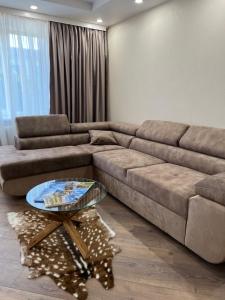 a living room with a couch and a table at Stradinya apartment in Ventspils