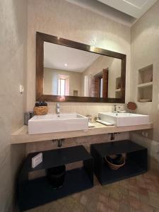 a bathroom with a sink and a large mirror at Riad Rossi in Marrakech +28 photos