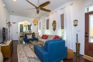 a living room with blue chairs and a couch at La Casa Boheme in Pensacola