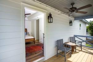 a porch with two chairs and a ceiling fan at La Casa Boheme in Pensacola