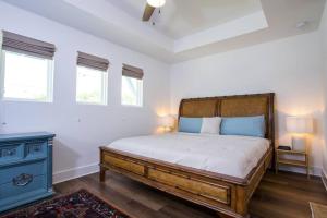a bedroom with a large bed and a blue cabinet at La Casa Boheme in Pensacola