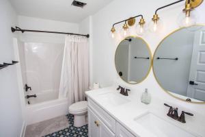 a white bathroom with a sink and a mirror at La Casa Boheme in Pensacola +15 photos