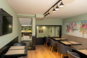 a restaurant with tables and chairs and a kitchen at Elm Suite Hotel in Istanbul