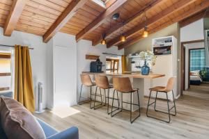 een keuken met een tafel en stoelen in een kamer bij Highlands di TSS' - Esclusivo Appartamento - Appena Rinnovato - Ottimo per Famiglie a Levico Terme in Levico Terme