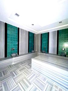 a dance floor with green tiles on the walls at Calypso Residence Kestel in Alanya