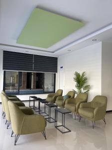 a waiting room with a row of chairs and tables at Calypso Residence Kestel in Alanya