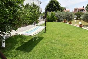 a hammock in the grass in a park at Xenophon House in Paleo Tsifliki