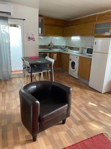 a kitchen with a chair and a table and a kitchen with a refrigerator at The Tiles House in Faro