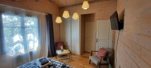 a living room with a bed and a window at Sea-Snow Guest Houses in Talmont