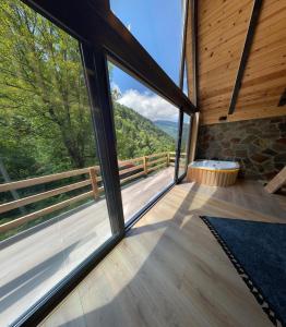a room with a large window with a view at Ayder Çalıkuşu Bungalov in Ayder Yaylasi