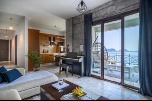 a living room with a couch and a piano at Zoe’s sea view in Pylos
