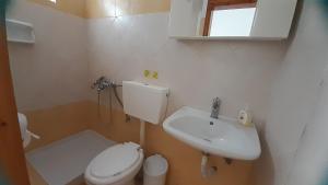 a small bathroom with a toilet and a sink at Avli Studios in Kokkino Nero