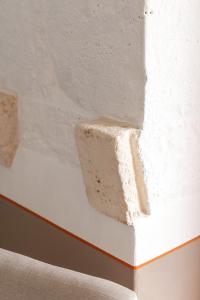 a corner of a white wall with a piece of plaster at Masseria Auraterrae in Polignano a Mare