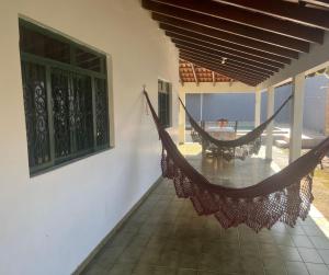 a hammock on the side of a house at CASA DE FÉRIAS II in Barra do Garças