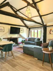 a living room with a couch and a table at Historic Property with Stunning Views (Walk to the pub) in Hennock