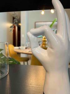 a white hand statue sitting on top of a table at Modern luxurious apartment in Santiago de los Caballeros