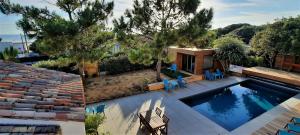 a swimming pool with chairs and a house at Sea-Snow Guest Houses in Talmont