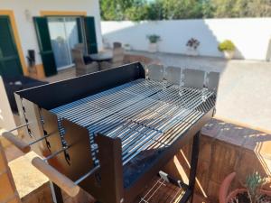 a barbecue grill sitting on top of a patio at Casa Luna, Burgau - Luz, Lagos in Burgau +47 photos