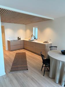 a large kitchen with a table and a counter at The Modern Fisherman Cabin Lofoten in Ballstad