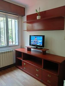 a living room with a television on a wooden dresser at Apartamento Patiño en Marín in Marín