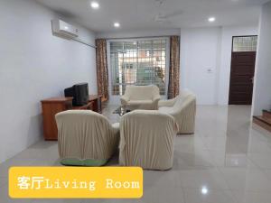 a living room with two chairs and a tv at Sibu wawasan no.1 Homestay in Sibu